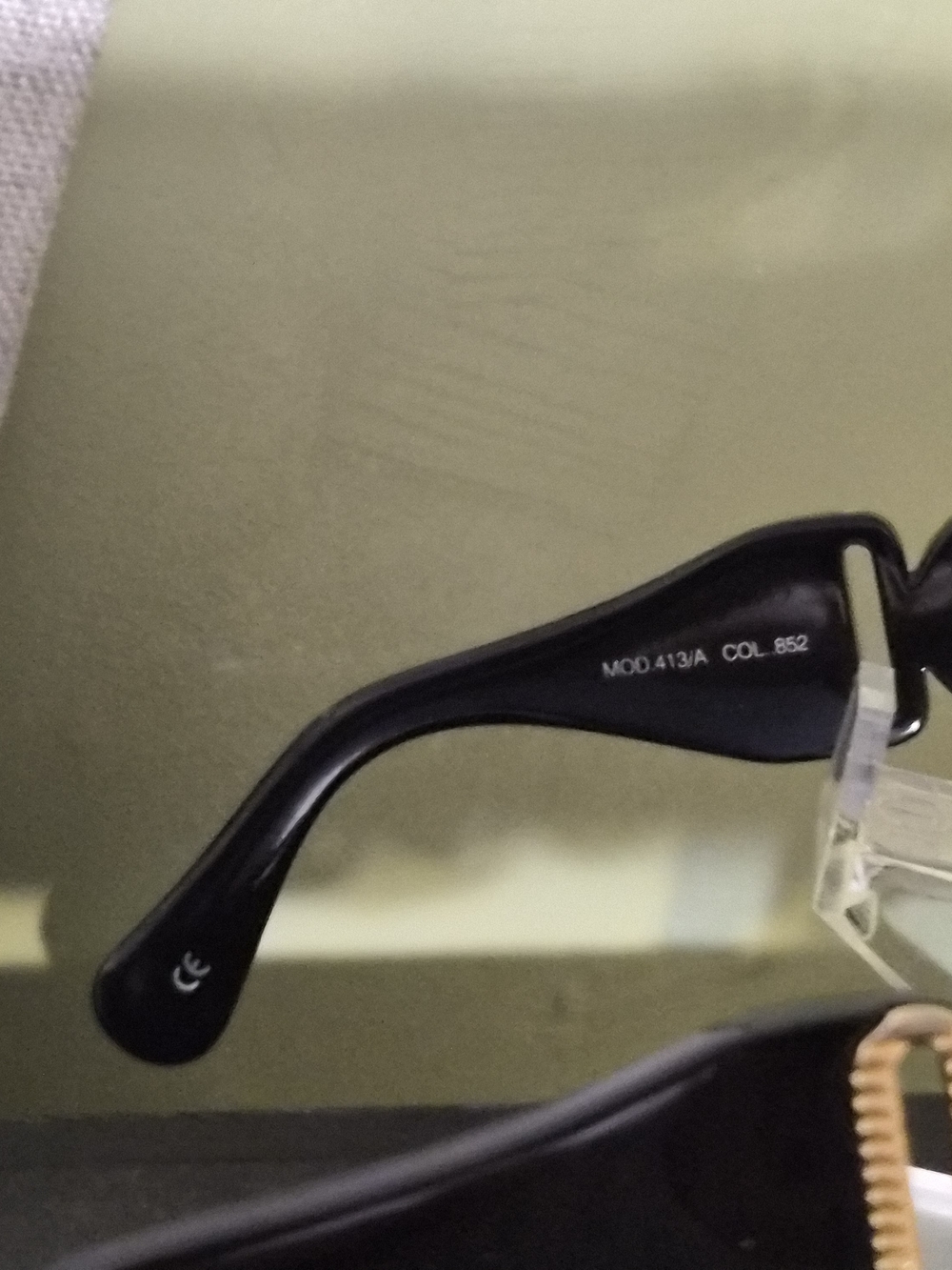 Black Sunglasses Arm with White Model Text